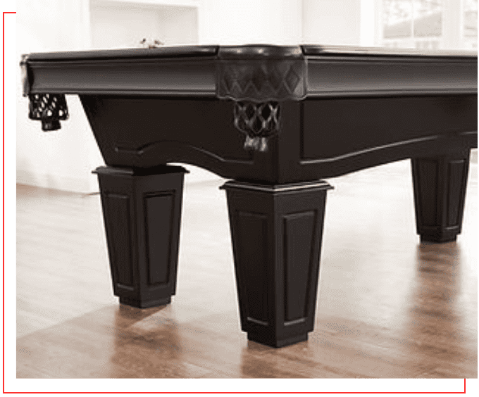 A black pool table in the middle of a room.